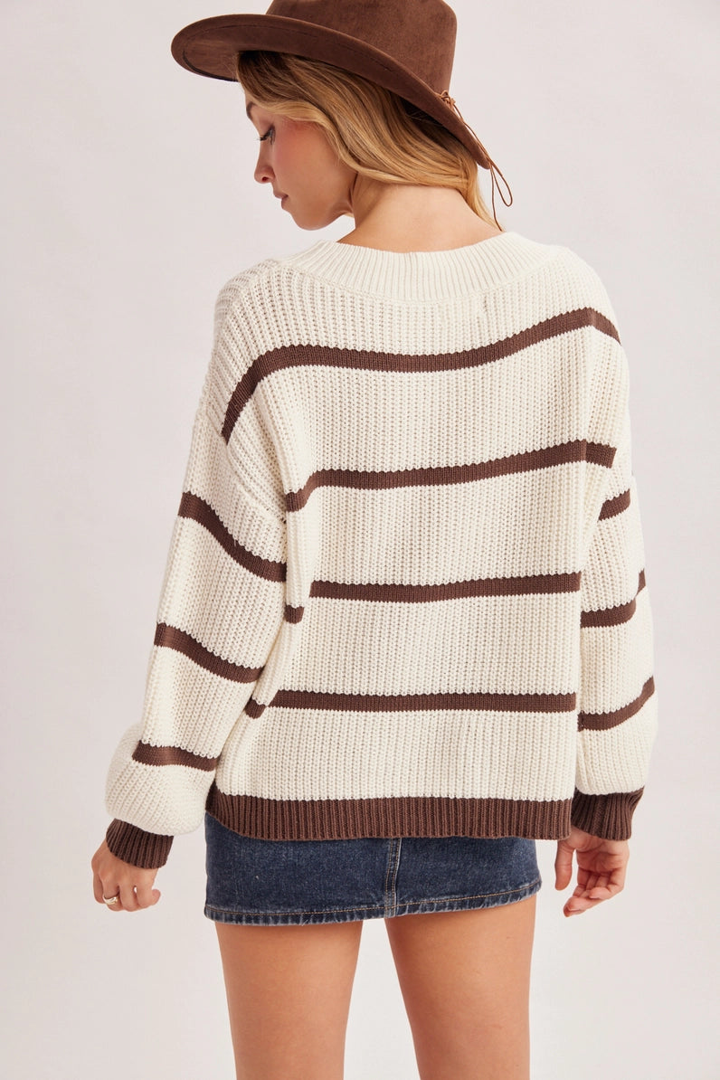 back view of woman in striped sweater and skirt