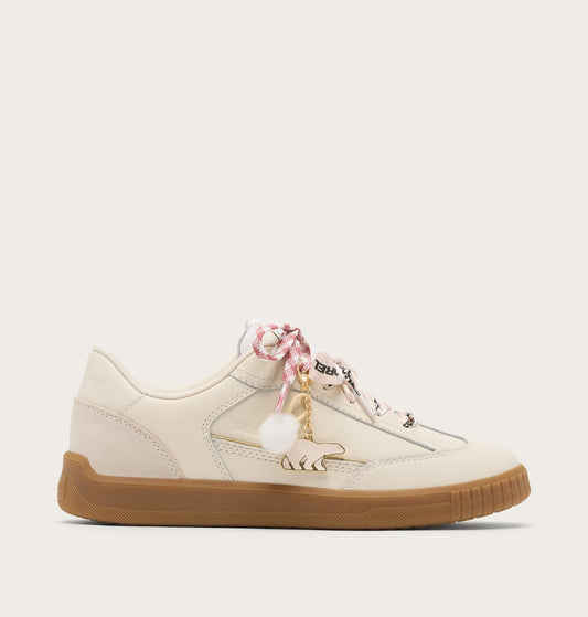 White sneaker with brown sole on a white background