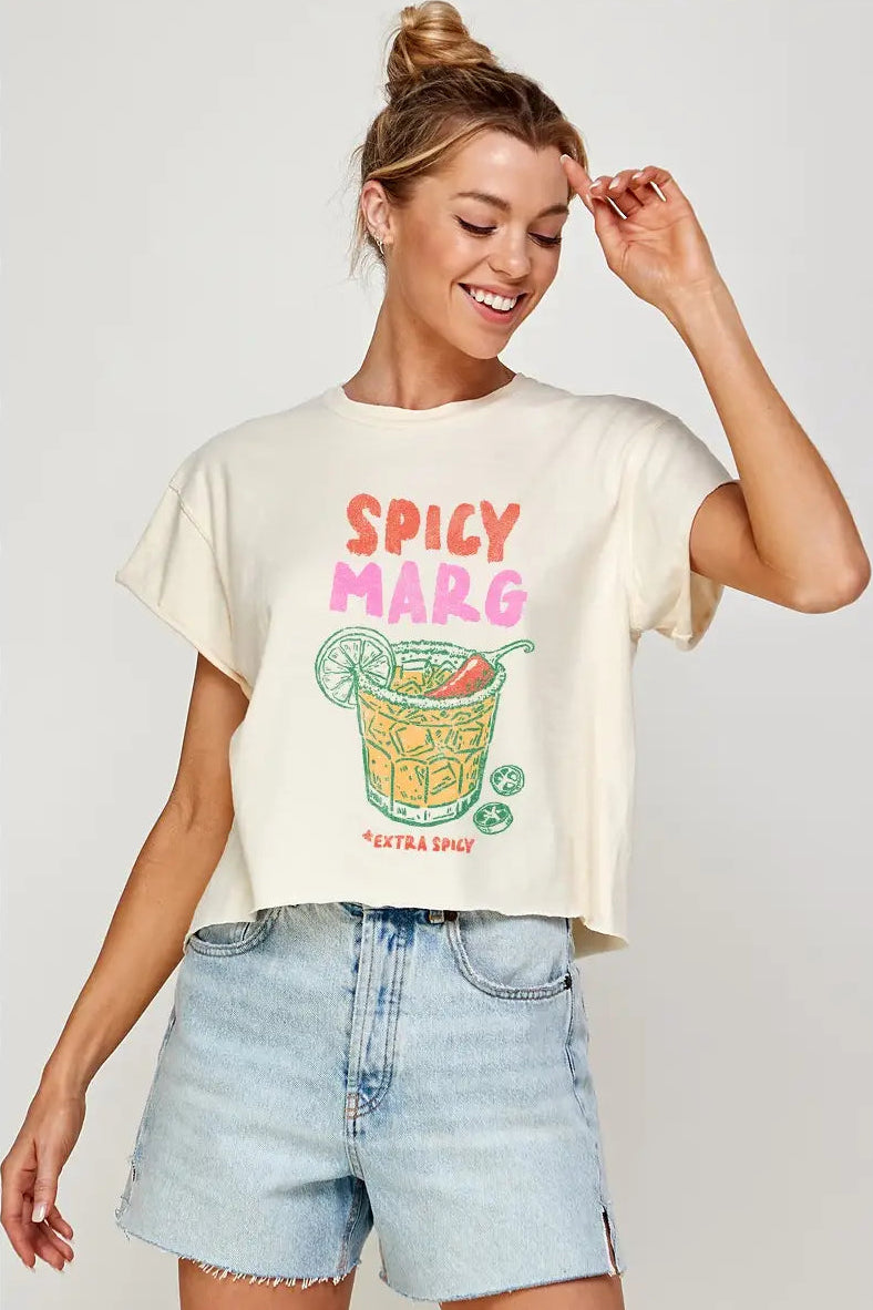 Woman wearing a 'Spicy Marg' t-shirt with a graphic design on a plain background