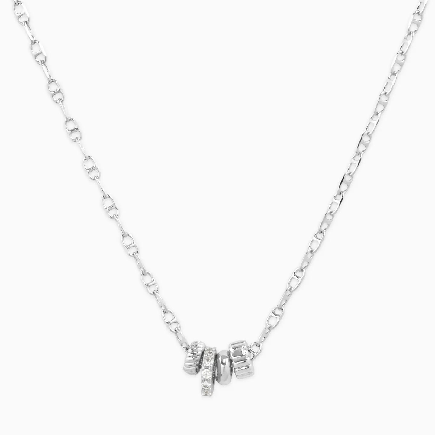Silver necklace with small pendants on a white background