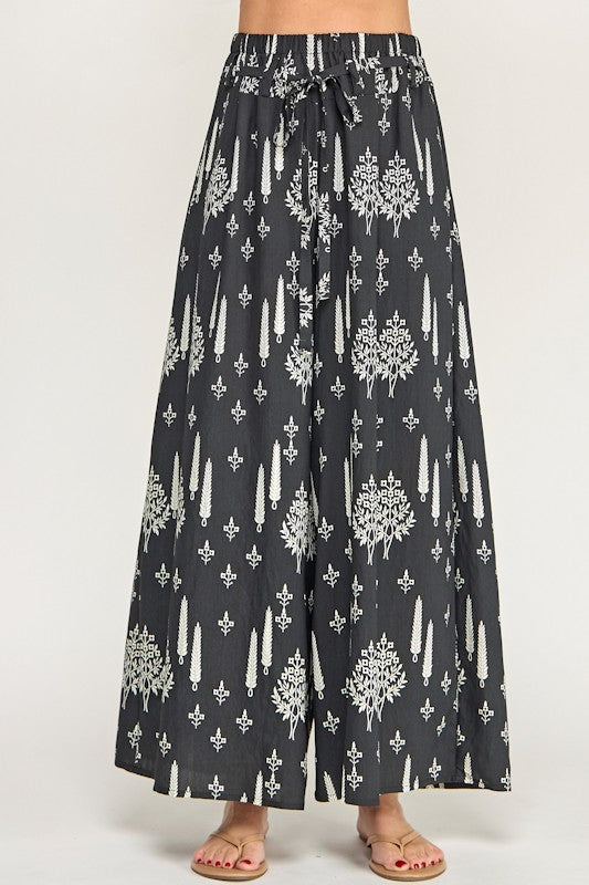 Black pants with white floral pattern on a white background