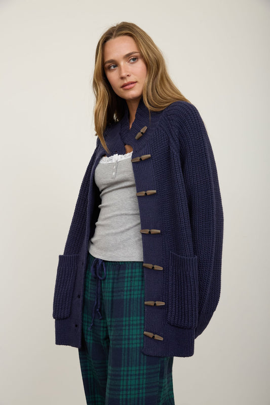 woman wearing navy cardigan with plaid pants