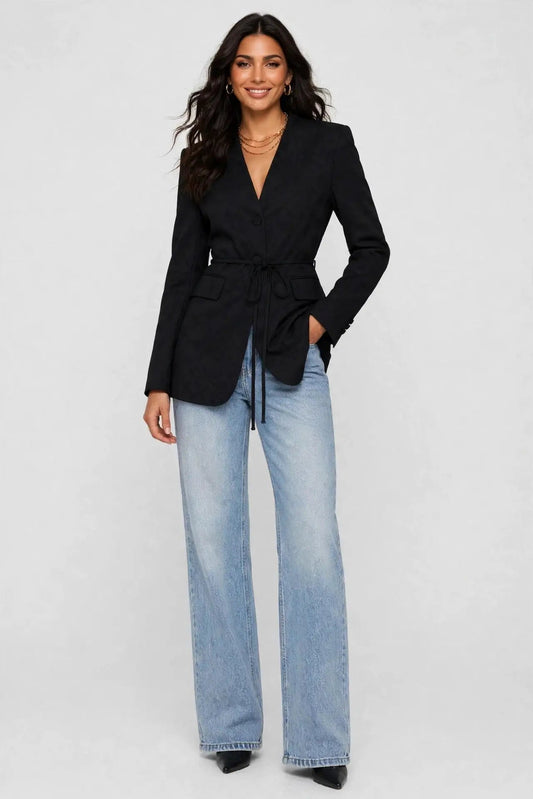 woman in tie blazer and jeans