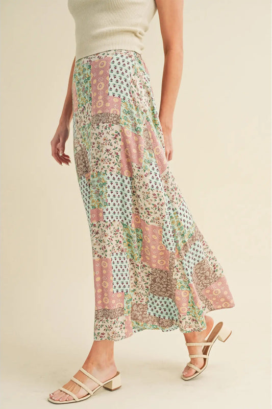 Woman wearing a floral patterned skirt on a plain background