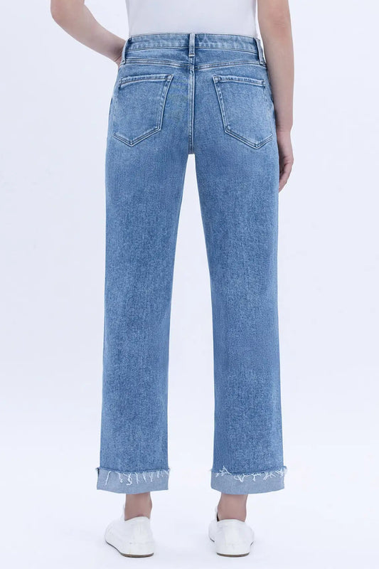 Light blue jeans worn by a person on a white background