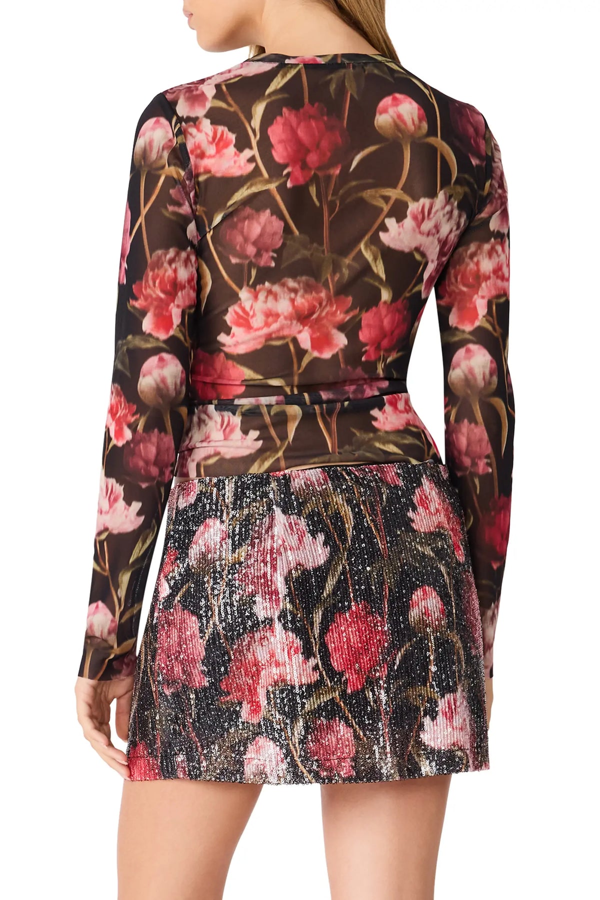 back view of woman in floral mesh top
