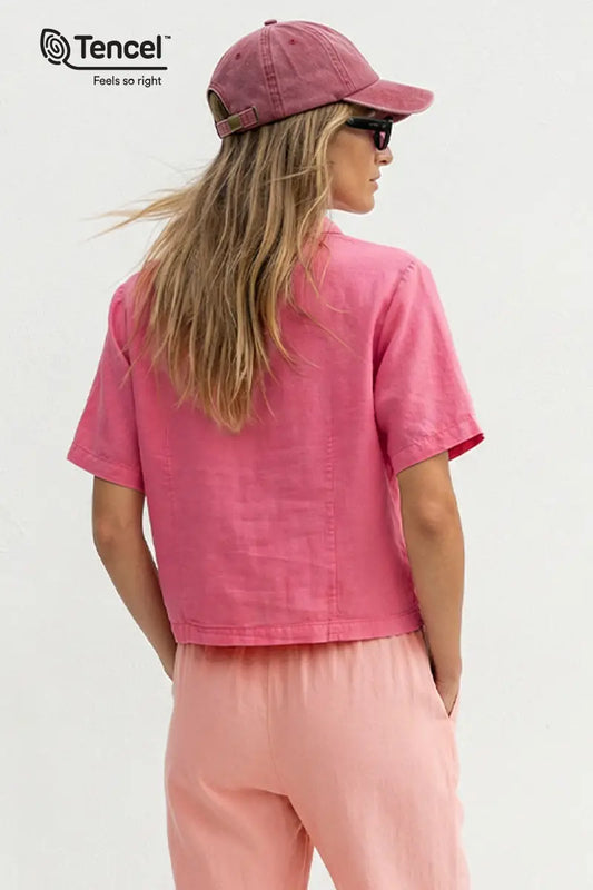 Person wearing a pink Tencel outfit on a white background