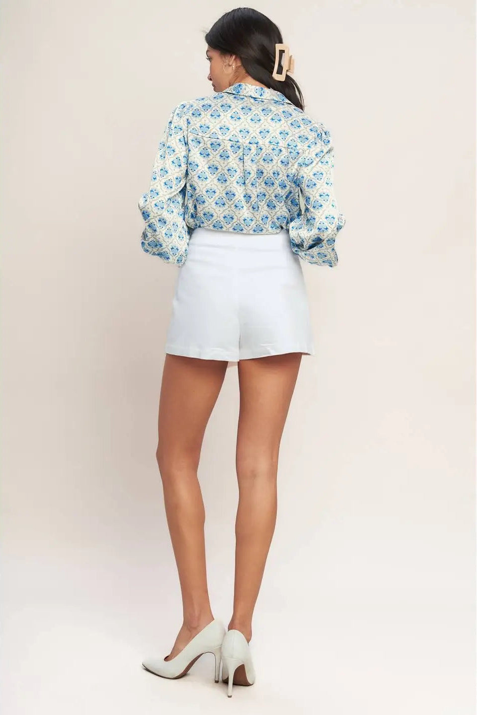 back view of woman wearing blouse with white skort