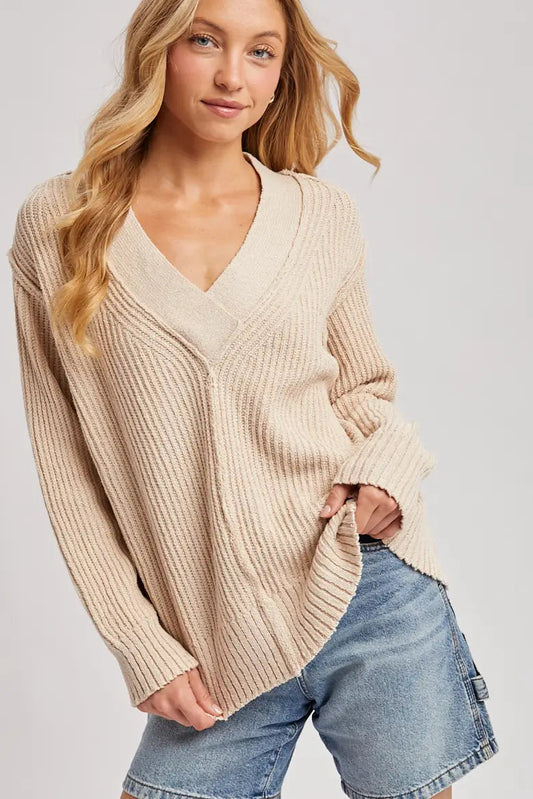 woman in v neck sweater and jeans