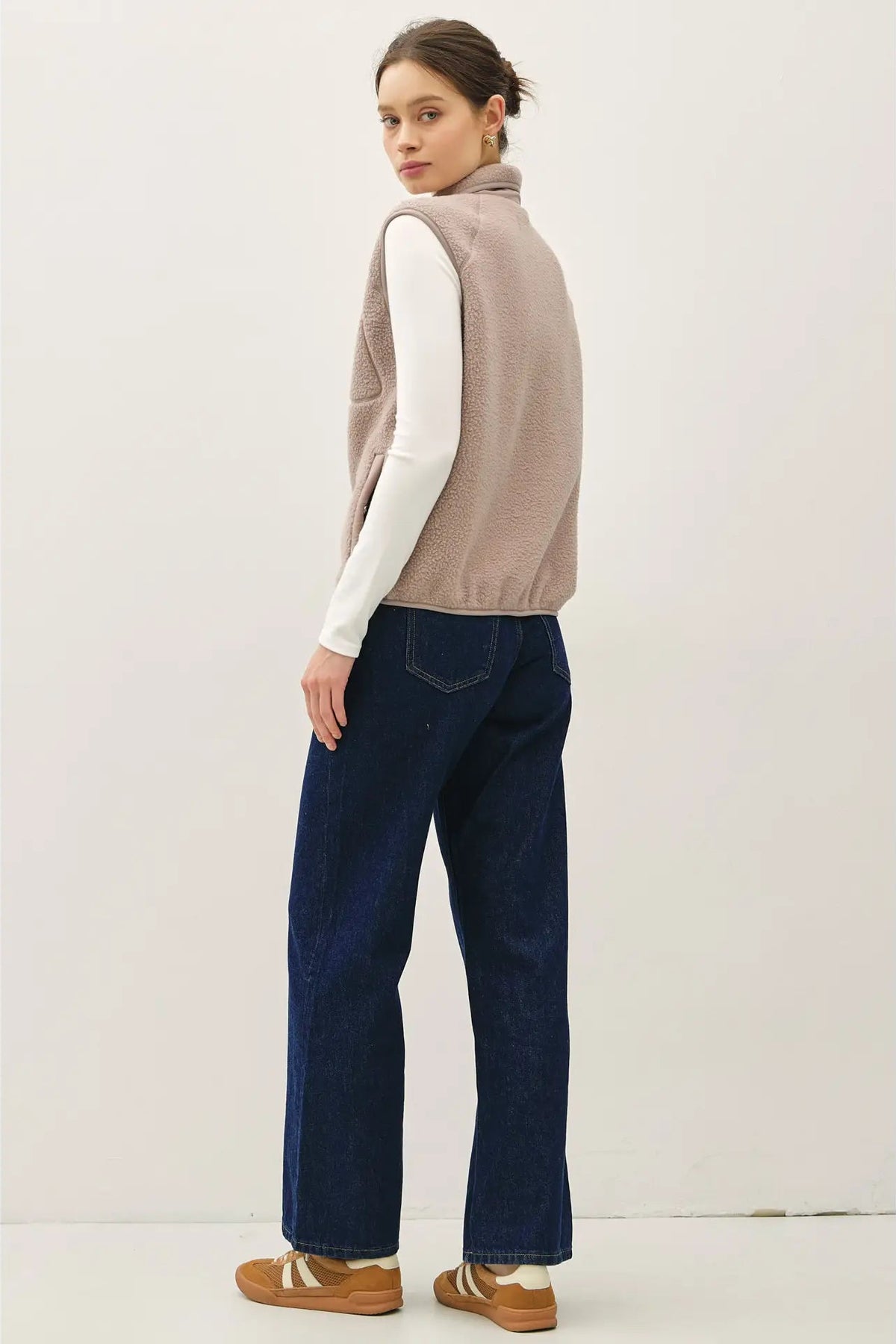 woman wearing fleece vest and jeans