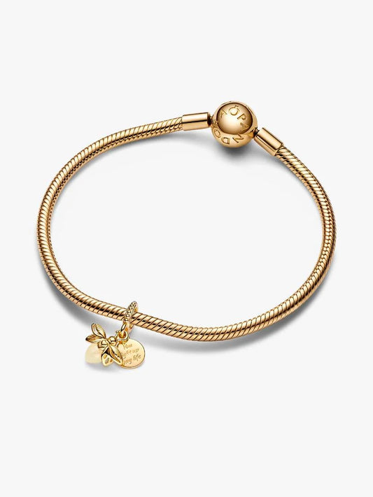 Gold bracelet with a heart charm on a white background