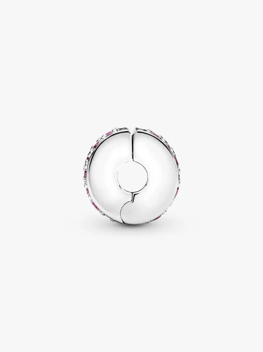 Silver charm with floral design on a white background