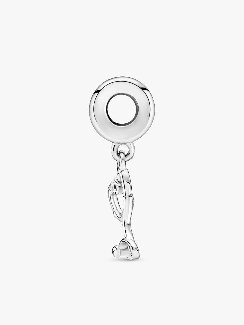 Silver charm with a circular design on a white background
