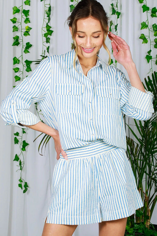 woman wearing blue and white button up shirt and shorts
