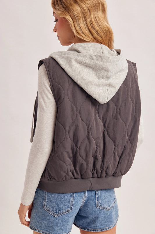 back view of woman in gray quilted vest