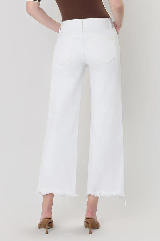 Person wearing white pants on a plain background