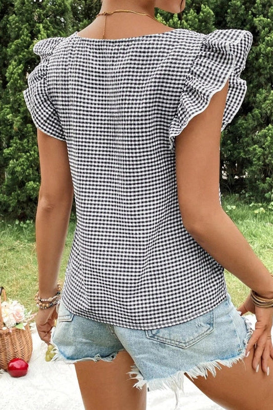 woman wearing gingham blouse