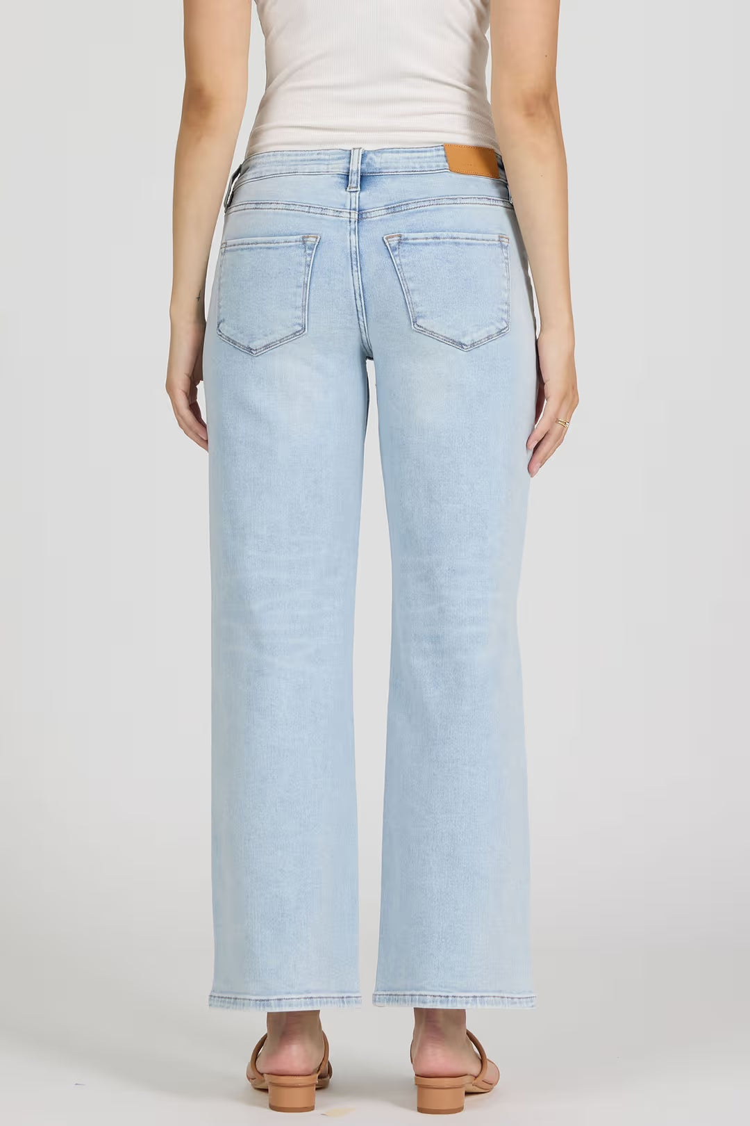 Light blue jeans worn by a person on a white background