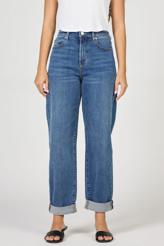 Blue jeans worn by a person on a white background