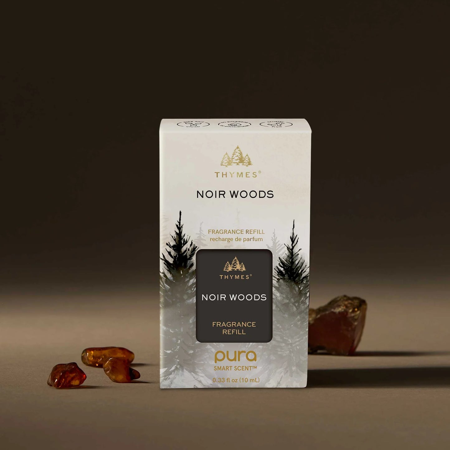 Thymes Noir Woods fragrance refill packaging on a brown background