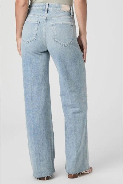 Light blue jeans worn by a person on a white background