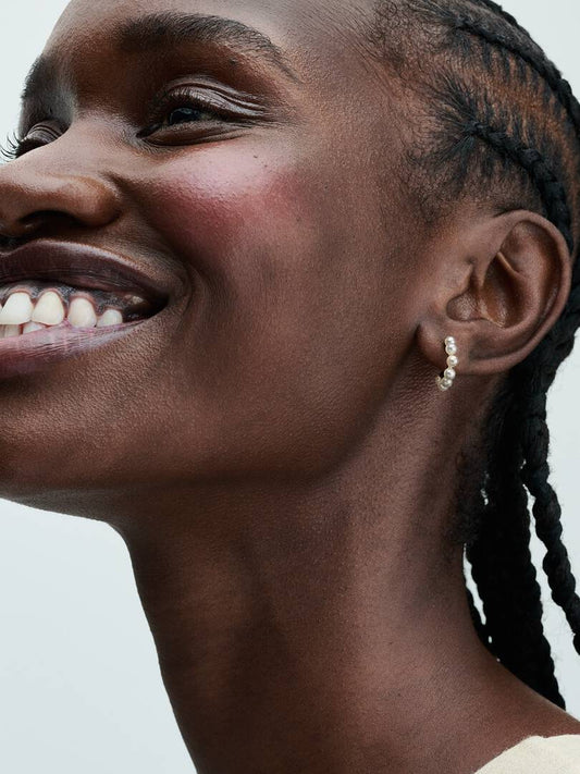 woman wearing pearl earrings