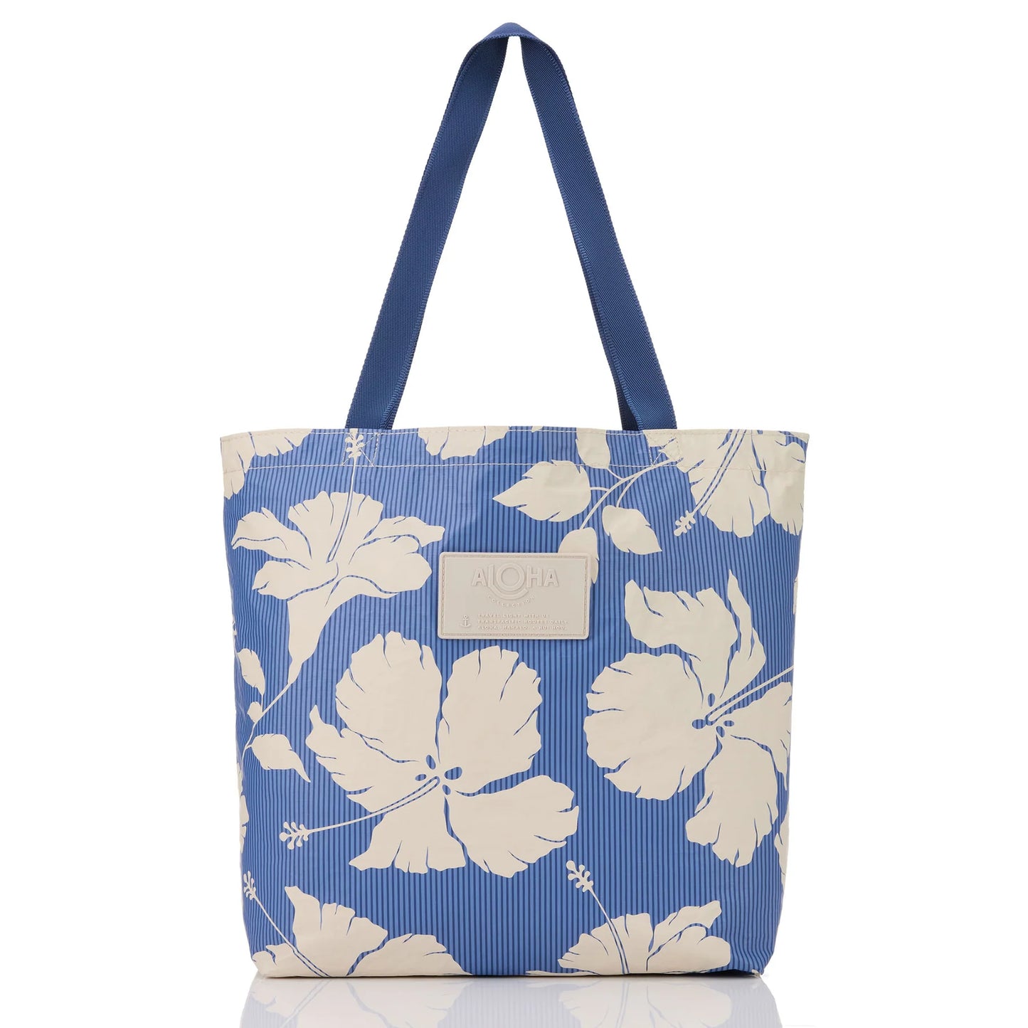 Blue tote bag with white floral pattern on a white background