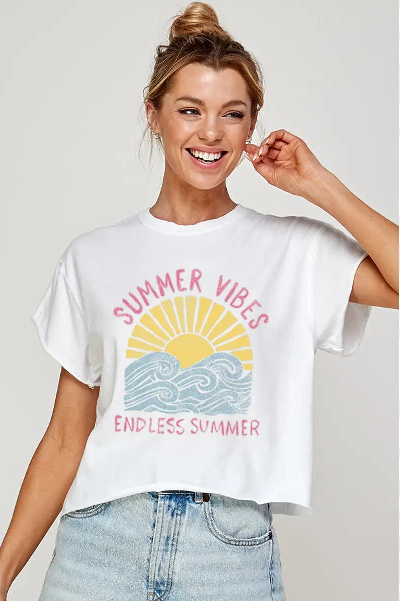 Woman wearing a white t-shirt with 'Summer Vibes Endless Summer' design on a plain background