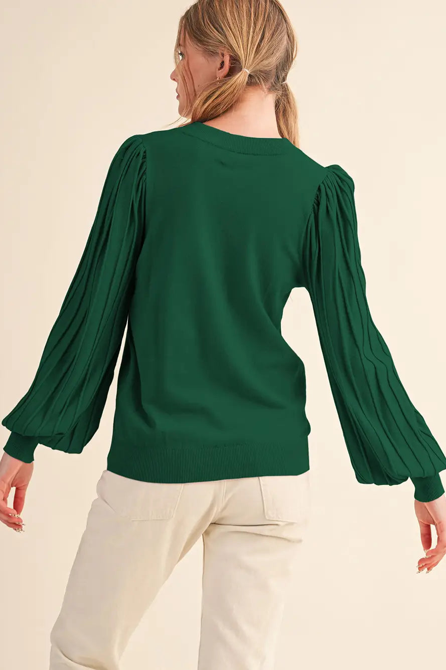 back view of girl in green sweater and white jeans
