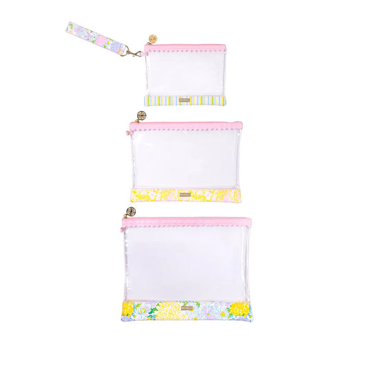 Set of three white pouches with colorful floral and polka dot patterns on a white background