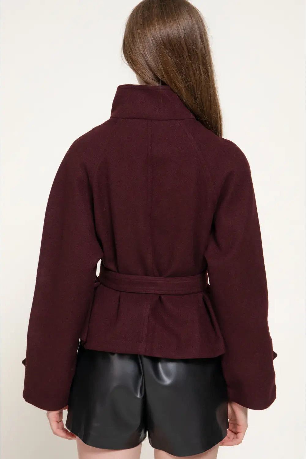 back view of woman in jacket and shorts