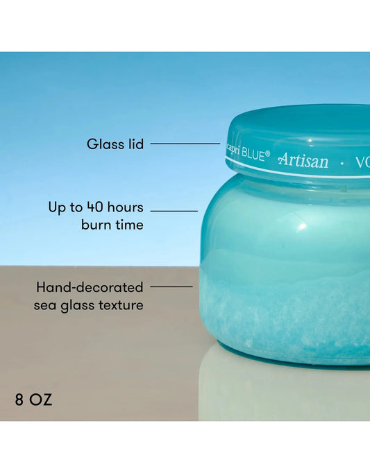 Blue candle jar with text detailing features on a blue background