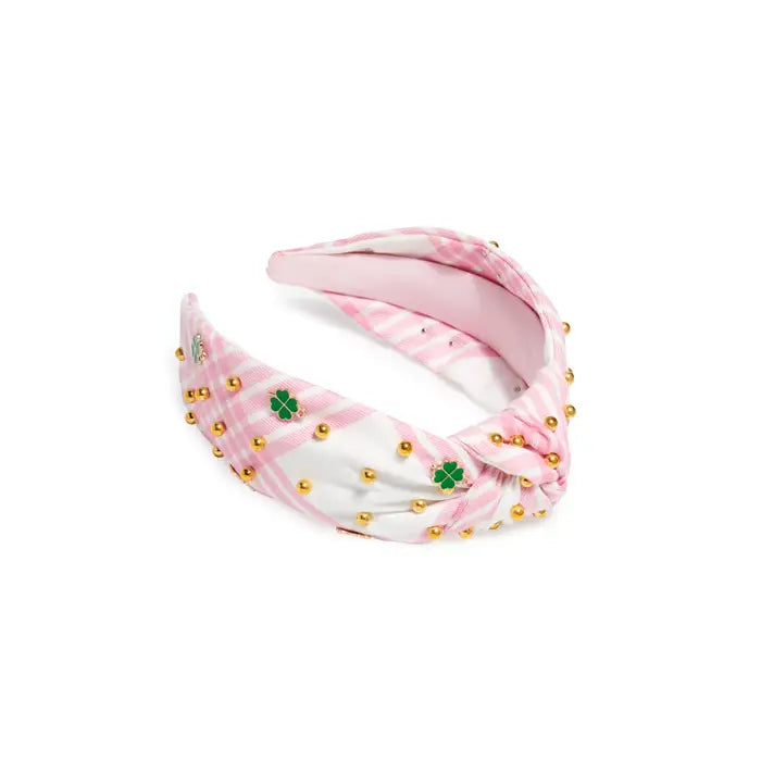 Pink and white headband with gold beads and green clover patterns on a white background