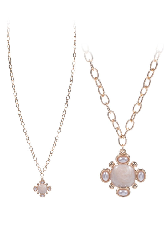 Two necklaces with floral pendants on a white background