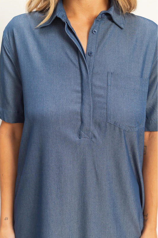 Blue short-sleeve shirt worn by a person on a white background