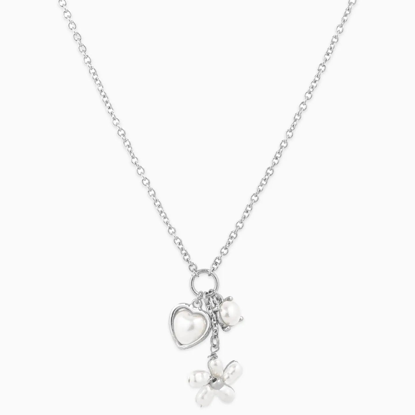 Silver necklace with heart, bow, and pearl charm on a white background
