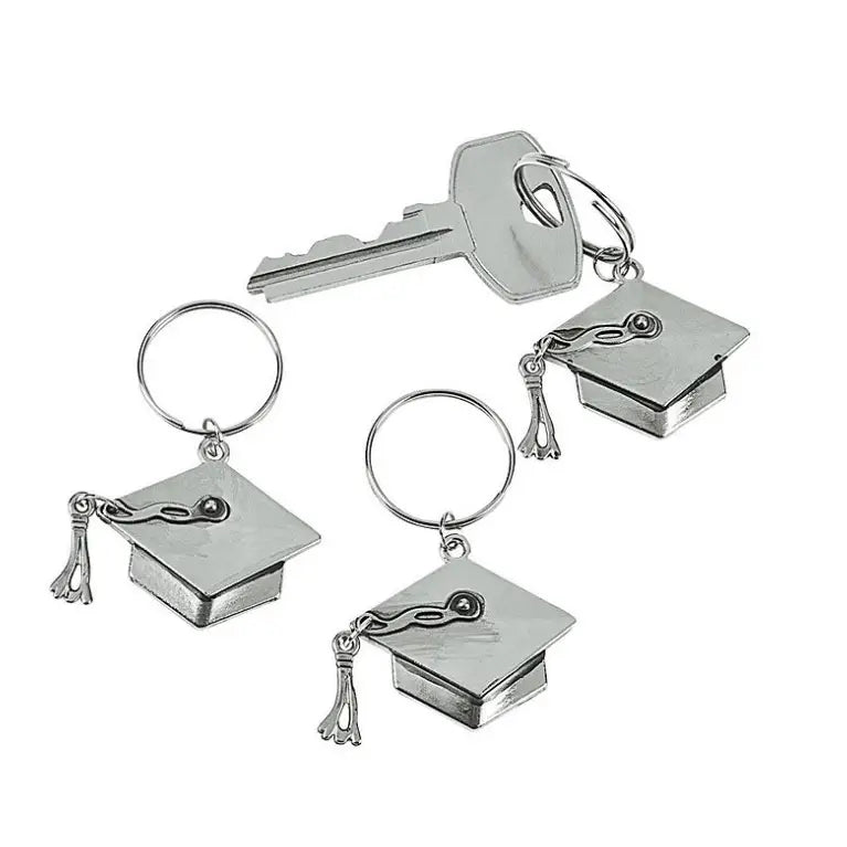 Set of silver keychains with graduation cap and tassel charms on a white background