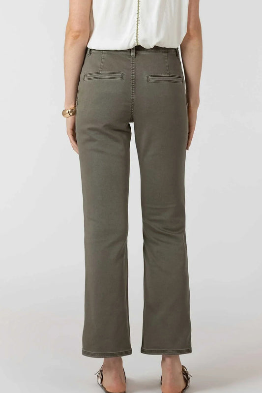 Person wearing olive green pants on a white background