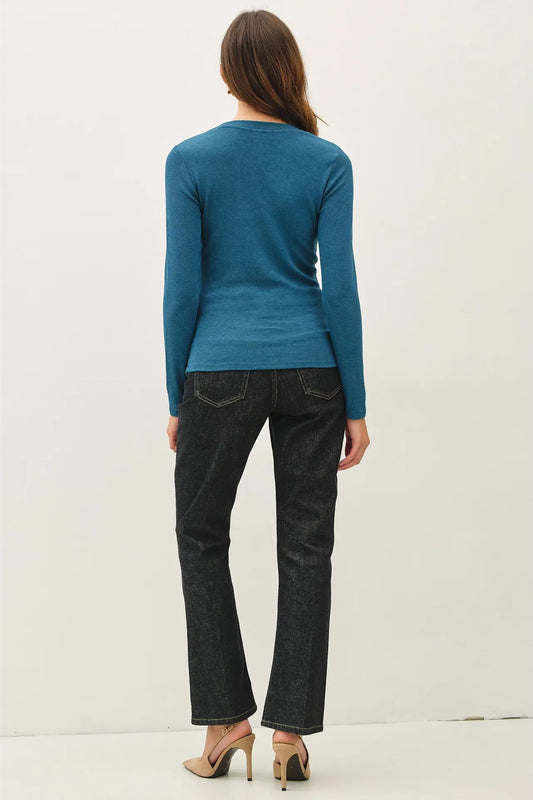 woman in long sleeve top and jeans