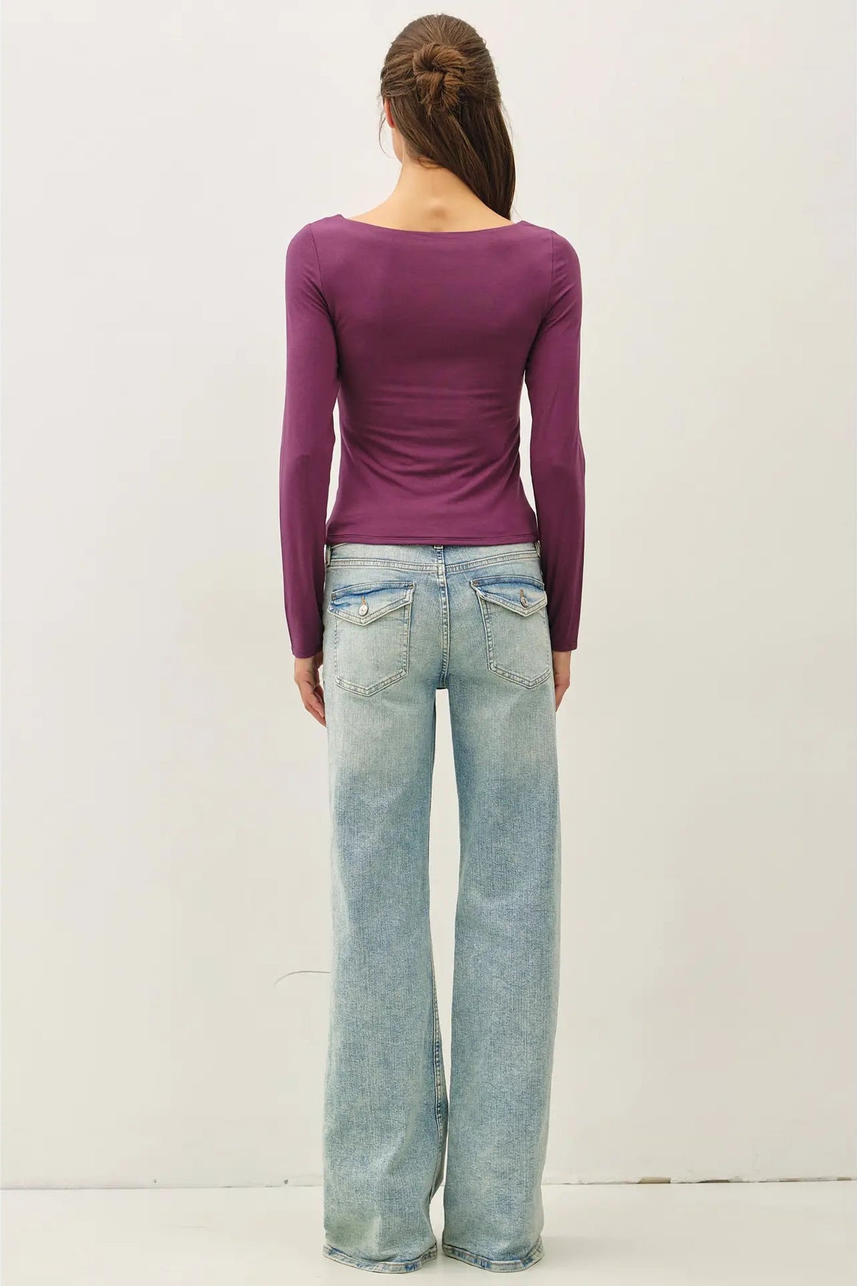 woman in long sleeve top and jeans