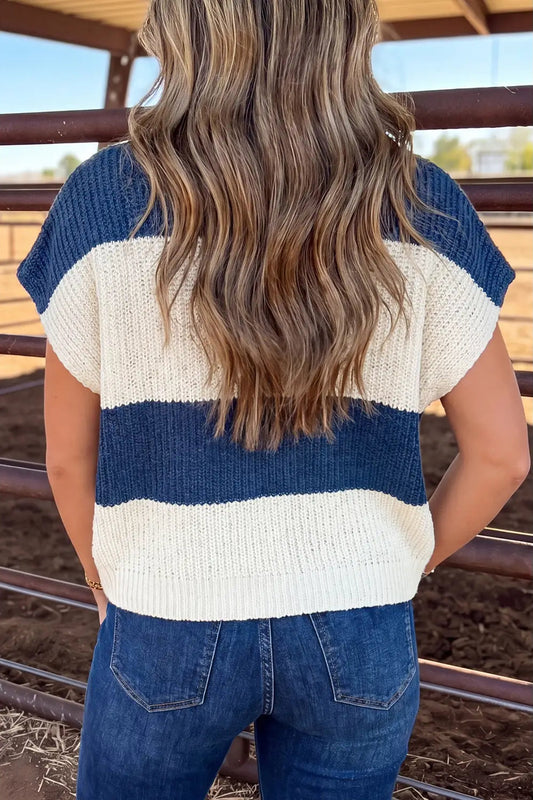 back view of woman in blue and white stripe weater in jeans