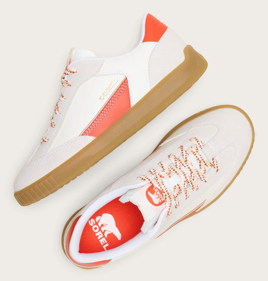 White sneakers with orange accents and a visible Sorel logo on a light background