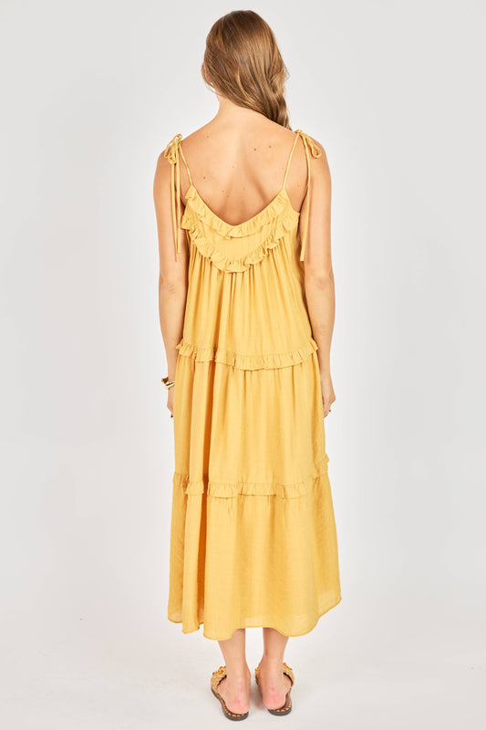 Woman wearing a yellow dress with a white background