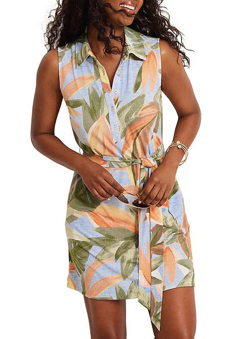 Woman wearing a sleeveless dress with floral pattern on a white background