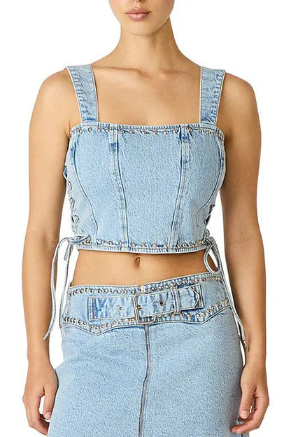 Light blue denim crop top and high-waisted pants on a white background