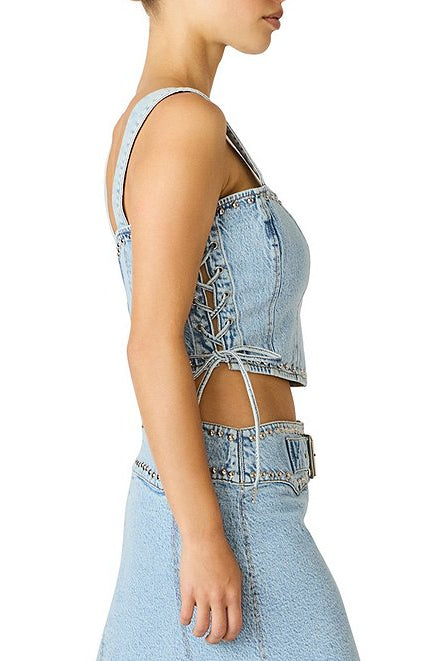 Light blue denim top with cut-out design on a white background