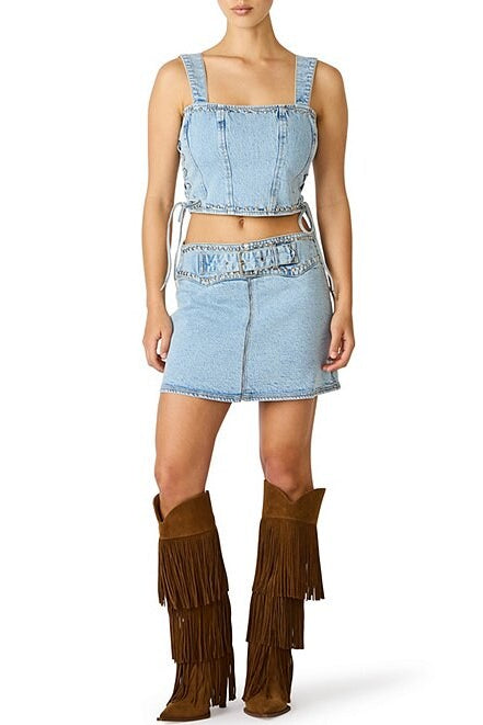 Denim outfit with fringed boots on a white background