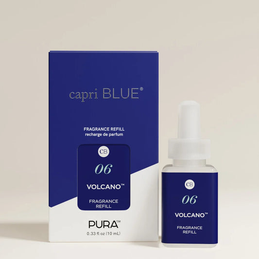 Pura Capri Blue Volcano fragrance refill set, featuring a blue and white retail box and a matching dropper bottle with a white cap, photographed on a clean light beige background.