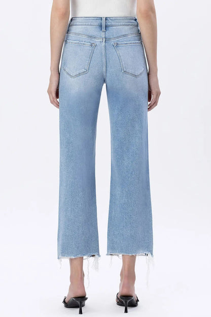 Light blue jeans worn by a person on a white background