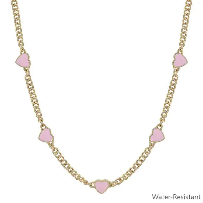 Necklace with pink heart-shaped pendants on a gold chain against a white background.
